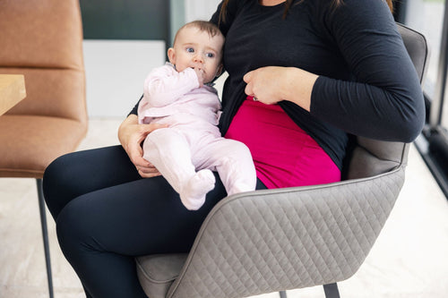 Mum breastfeeding her baby showing a breast vest top