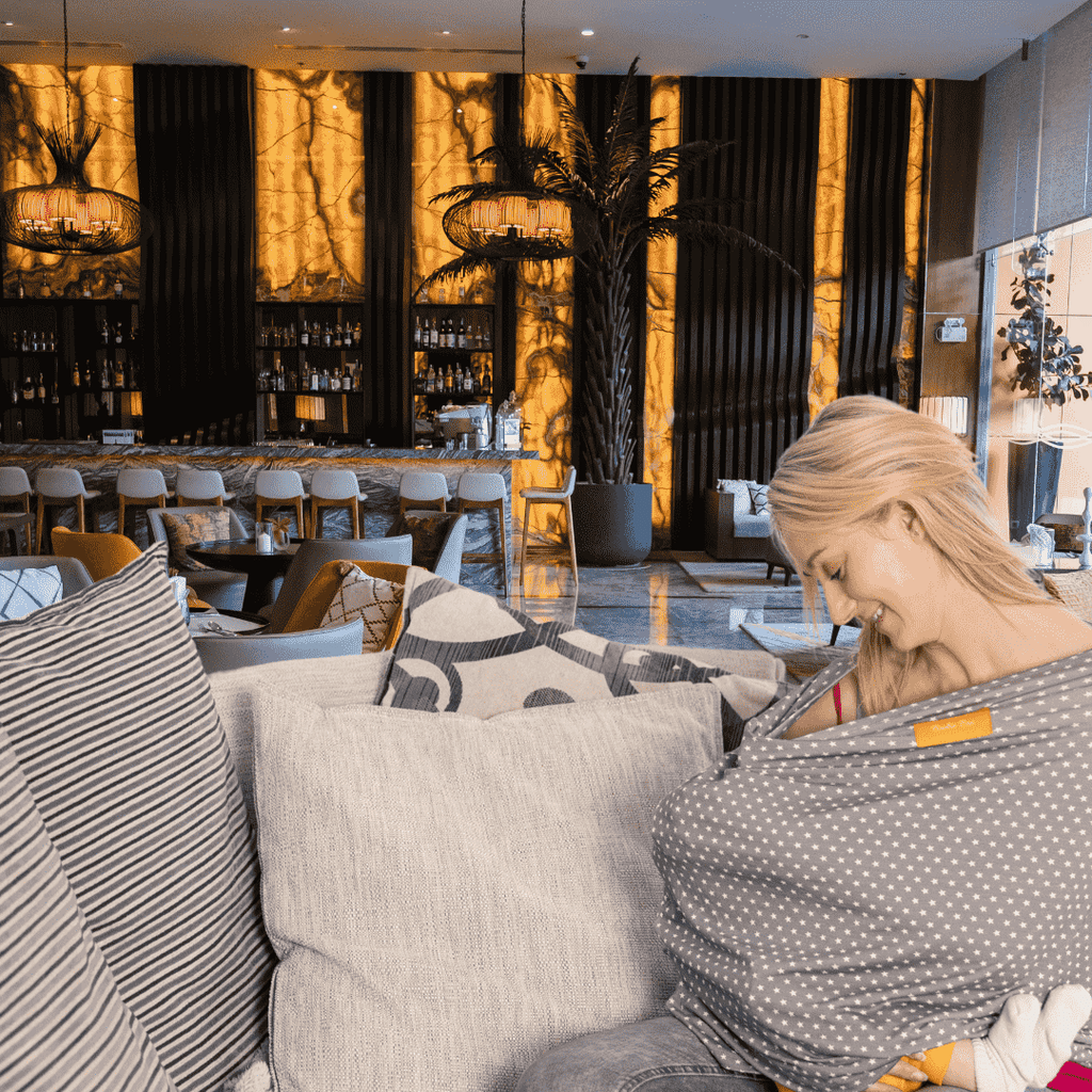 Breastfeeding Cover on Mum breastfeeding in hotel lobby